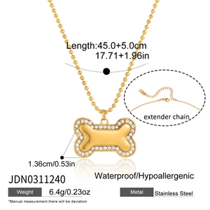 Detail showing gold stainless steel bone pendant with white cubic zirconia and ball chain