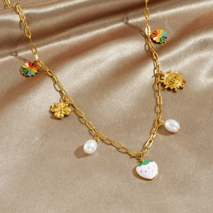 Gold-plated pastoral necklace with pearls, cherry, and heart charms on champagne silk