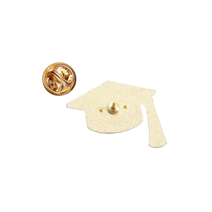 Macro view of gold doctoral cap pin back with butterfly clutch and sandblasted finish