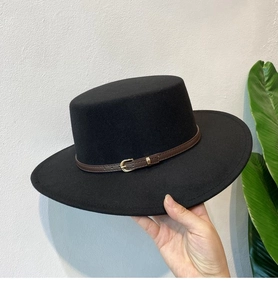 Detail of a black flat top wool fedora hat featuring a brown leather belt with gold buckle
