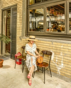 Elegant wide brim straw boater hat paired with a floral dress for a summer resort style