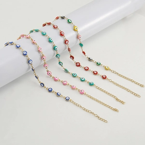 Set of five colorful 18K gold plated Turkish evil eye bracelets on a display stand