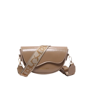 Beige patent leather saddle bag with broad fabric strap and chic front lettering