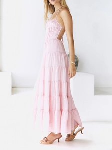 Side view of pink backless tiered halter dress with light layered skirt design