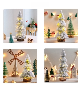 Mini tabletop flocked Christmas tree with warm LED lights and a natural wooden base