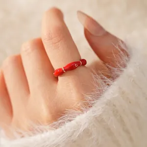 Elegant gold plated oval open ring with red enamel details and minimalist G engraving