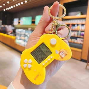Mini yellow handheld Tetris game console keychain with cute cartoon duck design