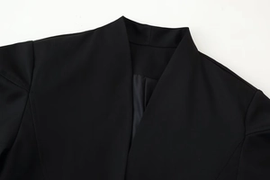 Detailed close-up of V-neck collar and structured shoulder on a black chic women blazer