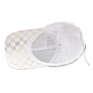 Detail view of the baseball cap's breathable mesh lining and gold checkered pattern
