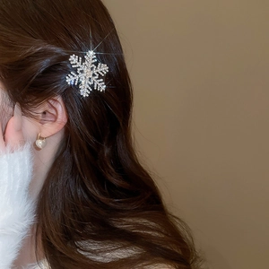 Sparkling snowflake hair clip with rhinestones worn on brunette hair with starburst effect