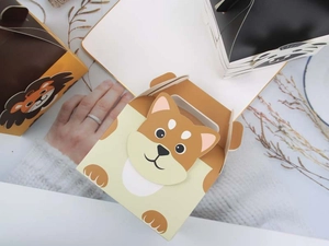 Detail of cute animal cartoon treat boxes with handles for wedding party candy packaging