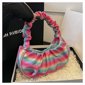 Detailed macro view of rainbow pleated satin fabric texture on stylish shoulder bag