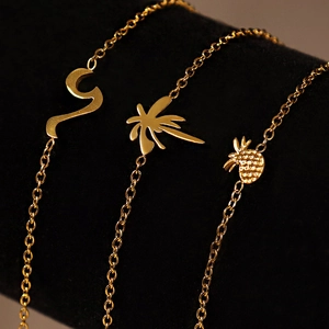 Polished 18k gold titanium bracelets featuring palm tree, pineapple and curve charms