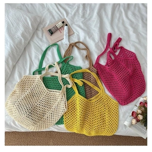 Flat lay of colorful large-capacity woven tote bags in beige, green, brown, and pink colors