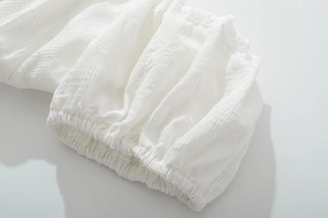 Detailed macro view of white checkered jacquard fabric with elastic cuff sleeves
