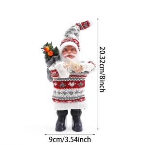 Plush Christmas Santa Claus figurine in grey knit sweater holding a small white tree