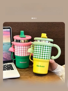 Detail view of colorful checkered stainless steel tumblers with handles and dustproof straws