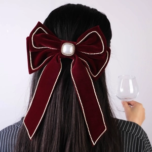 Large burgundy velvet bow hair clip with rhinestones and pearl detail for women