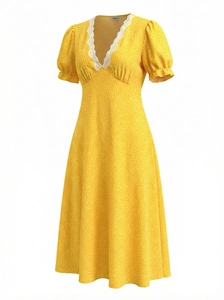 Detail of yellow polka dot dress with white lace V-neckline and puff sleeves