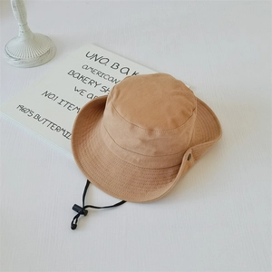 Close-up of khaki outdoor sun hat with adjustable chin strap and side metal snaps