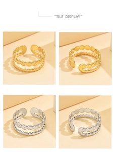 Flat lay display of vintage gold and silver layered coin rings with hammered textures