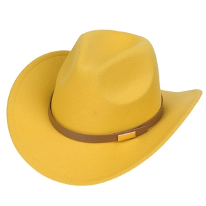 Detail of yellow cowboy hat with brown leather belt and gold metal buckle close-up