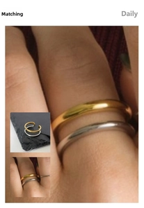 Detailed view of two-tone double-layered titanium steel ring in gold and silver