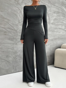 Detail of slim fit off-shoulder long sleeve top and high waist wide leg pants set in black
