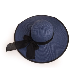 Detail of navy straw hat featuring fine weave texture and elegant black mesh bow decoration