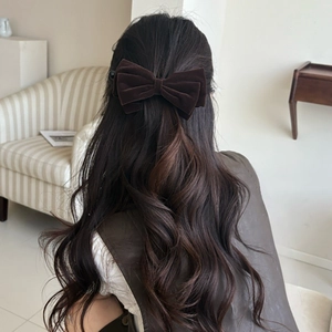 Elegant dark brown velvet bow hair clip shown on model for a vintage aesthetic style