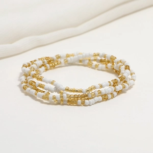 Detail of double-layered beaded waist chain with yellow and white glass seed beads