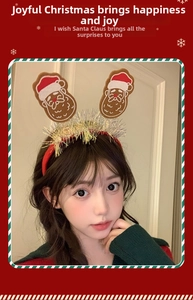 Close-up of a Christmas headband featuring a Santa Claus motif and shiny sequins