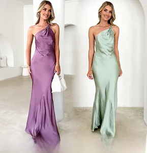 Detail of one-shoulder satin maxi dresses in purple and green with a sleek slim fit