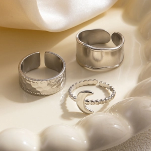 Detailed view of silver stackable ring set including hammered texture and moon charm design