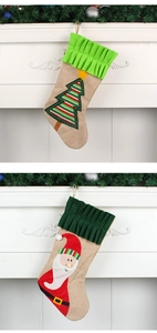 Detailed view of large Christmas stockings with 3D Santa and tree on festive mantel