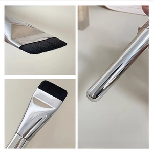 Macro shot of dense fiber bristles, thickened metal ferrule and silver waterproof handle
