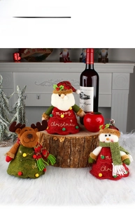 Close-up of Santa, Reindeer, and Snowman plush Christmas wine bottle gift bags set