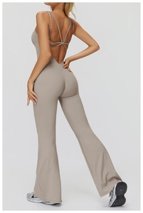 Rear view of crossover strappy back and flared leg design on nude yoga jumpsuit