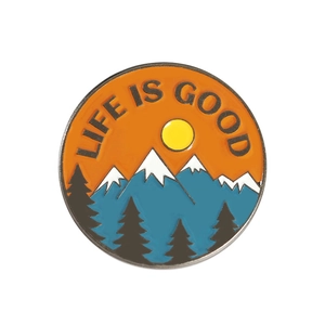 Detail of round enamel brooch featuring blue mountains and Life is Good text
