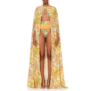Detailed close-up of vibrant floral print beachwear set with tassel waist and matching cape