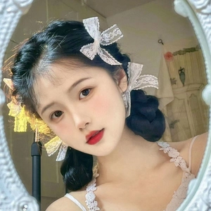 Detail of white lace bow hair clips for girls, showcasing elegant embroidery and vintage style