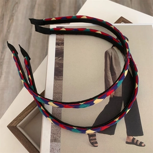 Colorful woven heart headband set in red blue and yellow on minimalist fashion magazine