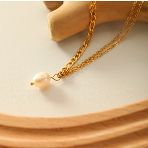 Close-up of dual chain 18K gold plated titanium necklace with natural freshwater pearl