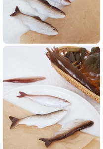 Detailed close-up of realistic faux fish charms with gradient scales and fine fin textures