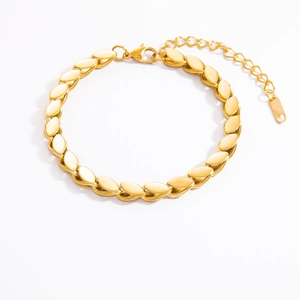 Close-up of golden leaf-shaped link bracelet with lobster clasp and extension chain