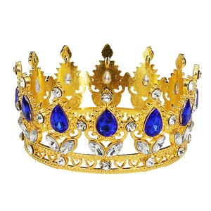 Detail of baroque gold crown with blue teardrop gems and sparkling crystals