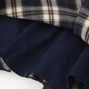 Plaid tiered camisole top with navy blue lining and layered ruffle hem design