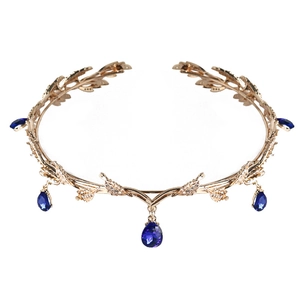 Detailed view of golden leaf bridal crown featuring blue teardrop rhinestone pendants