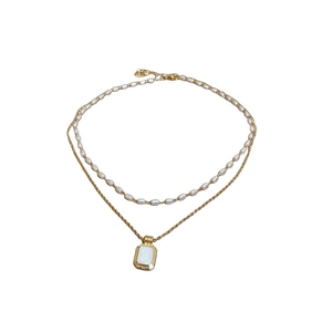 Double-layered gold necklace with small white pearls and vintage rectangular pendant