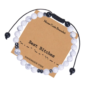 Detail of Morse code bracelet with white turquoise beads on a handmade display card